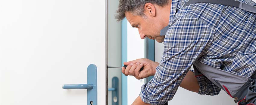 ADL-Technician Fixing Lock In Door With Screwdriver
